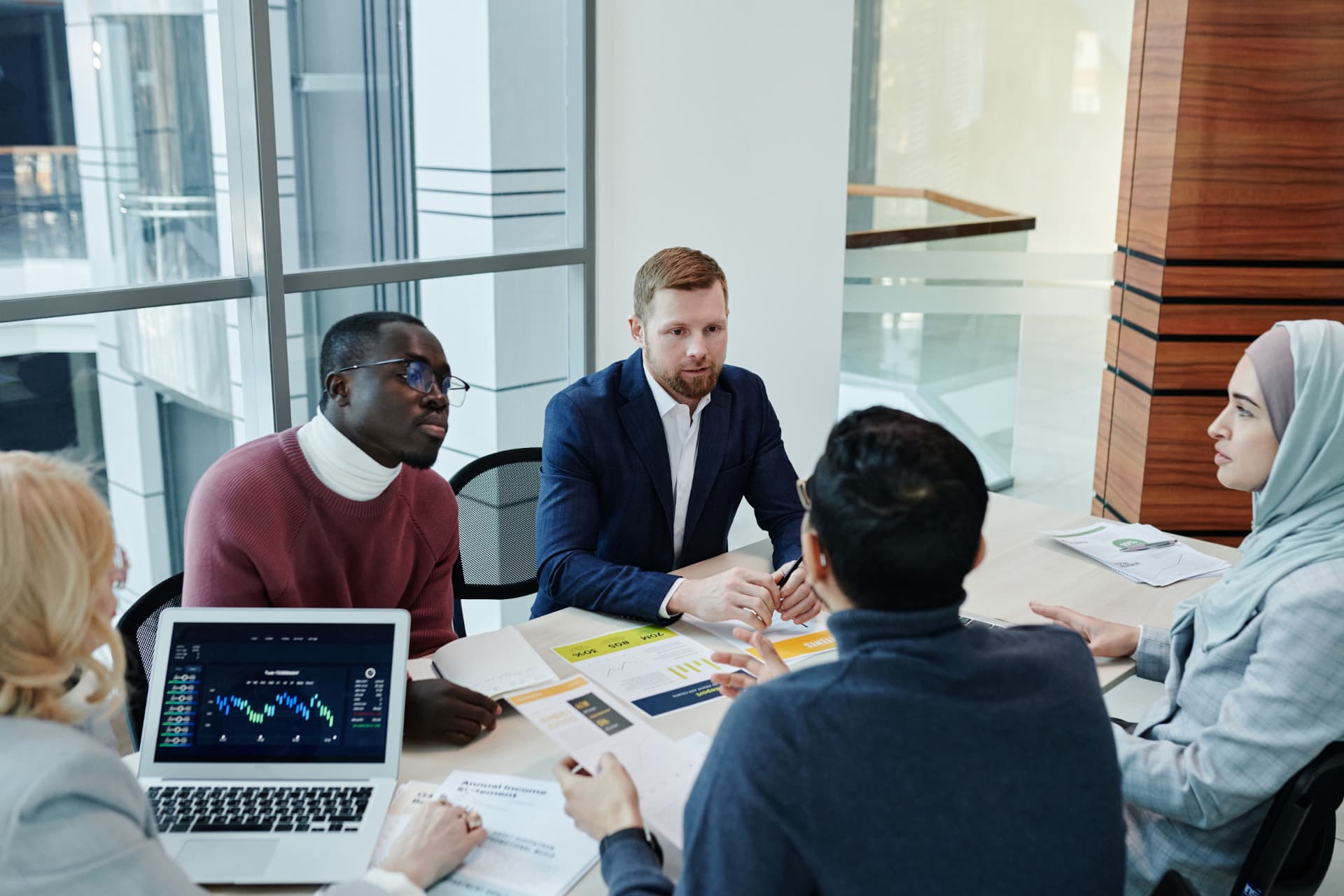 Consultants in discussion around a table in a bright office